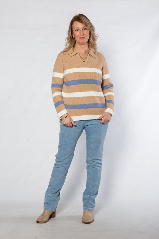 Woman wearing a striped sweater and jeans on a white background
