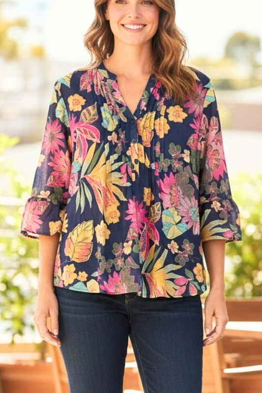 Equinox Clothing navy multi floral print shirt with 3/4 bell sleeves and a pleated front worn by a smiling woman