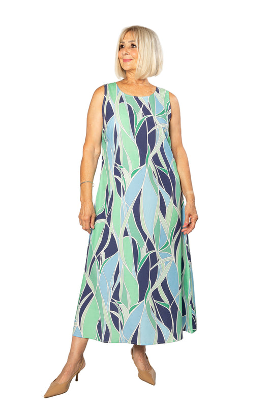 Woman wearing a sleeveless dress with a leaf pattern on a white background