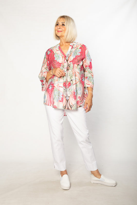 Equinox clothing white Bengaline pants worn with a colourful raspberry print flattering shirt
