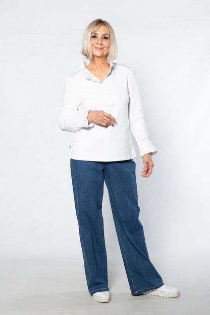 Woman wearing a white shirt and blue jeans on a white background