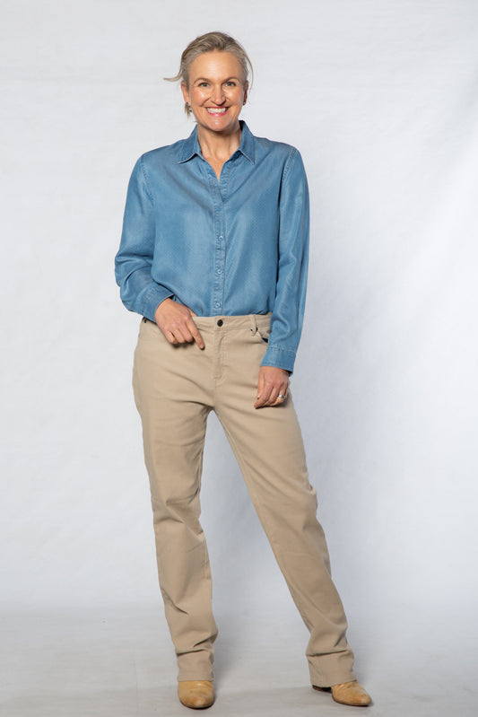 Person wearing a blue shirt and beige pants on a white background