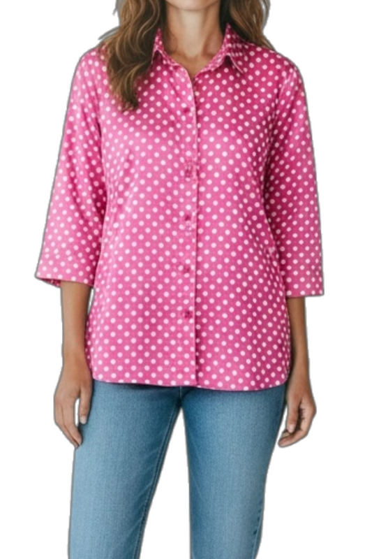 Woman wearing a pink polka dot shirt and blue jeans on a white background