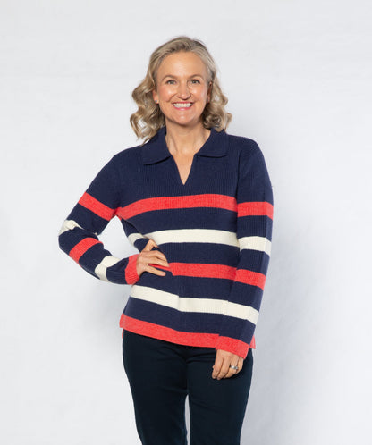 Woman wearing a striped sweater and dark pants on a white background