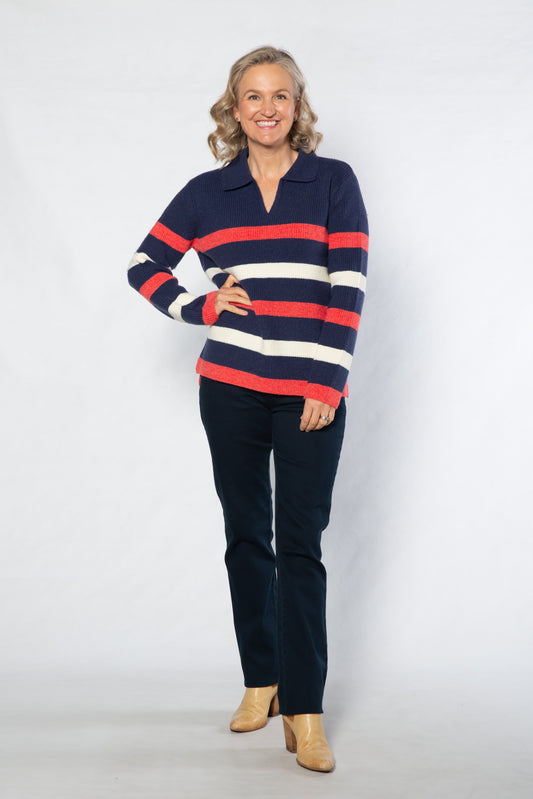 Woman wearing a striped sweater and dark pants on a white background