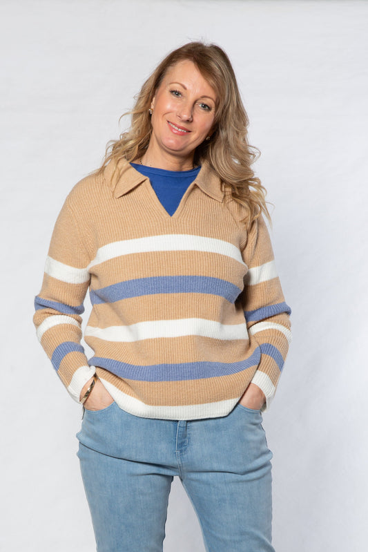 Woman wearing a striped sweater and jeans on a white background
