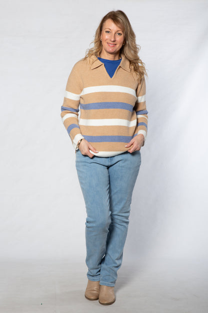 Woman wearing a striped sweater and jeans on a white background