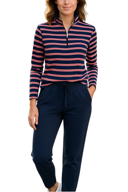 A woman modeling a long-sleeve quarter-zip pullover with navy, pink, and white horizontal stripes, paired with navy drawstring pants, against a plain white background.