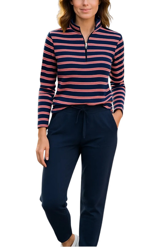 A woman modeling a long-sleeve quarter-zip pullover with navy, pink, and white horizontal stripes, paired with navy drawstring pants, against a plain white background.