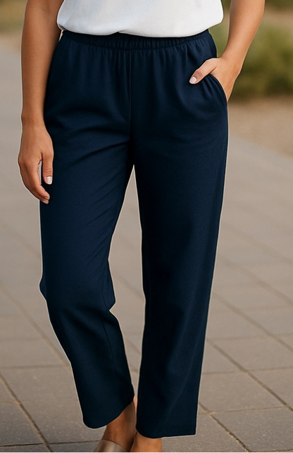 Model wearing Equinox Clothing #6425 Navy 7/8 straight-leg pull-on pants with a white top and beige flats