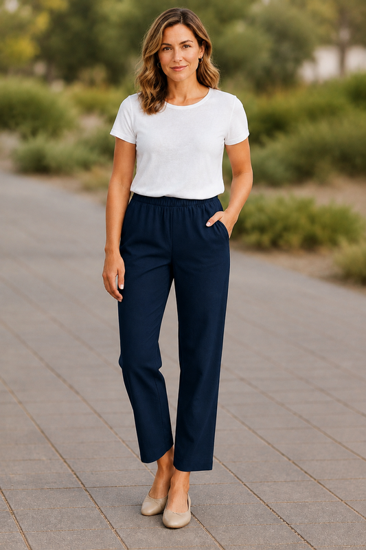 Model wearing Equinox Clothing #6425 Navy 7/8 straight-leg pull-on pants with a white top and beige flats