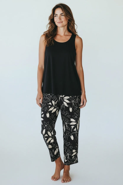 Equinox Clothing black sleeveless stretch cotton tank top with open side seams worn by a model with floral pants