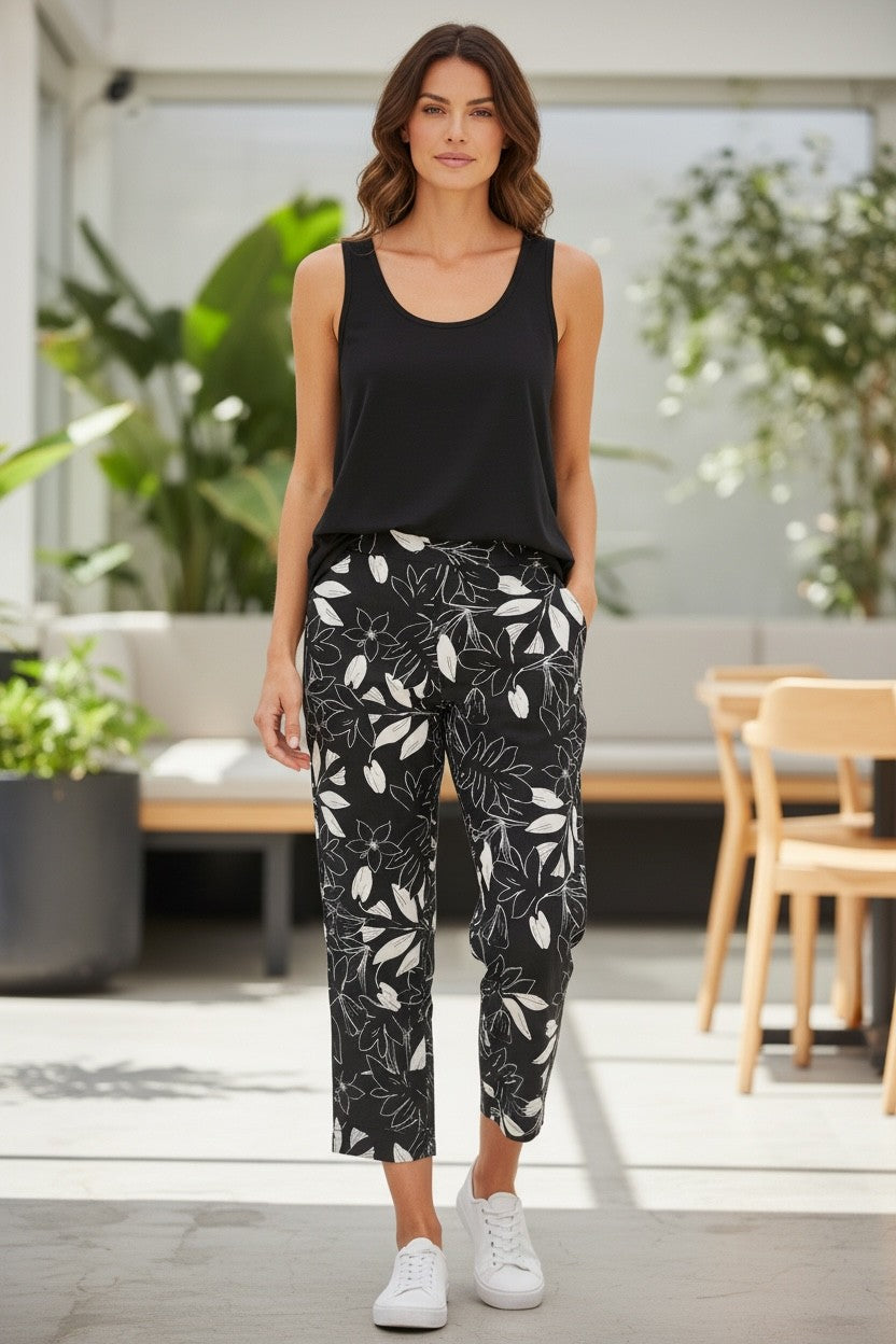 Equinox Clothing sleeveless black cotton tank top paired with floral print trousers on a model
