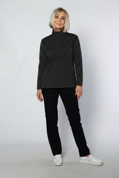 Equinox Clothing model wearing a black and white spot print mock turtle skivvy in a soft cotton blend fabric