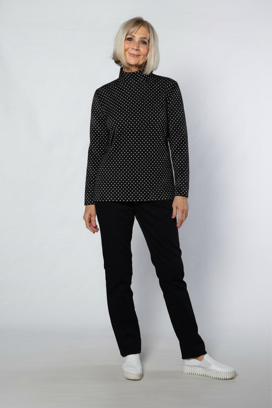 Equinox Clothing model wearing a black and white spot print mock turtle skivvy in a soft cotton blend fabric