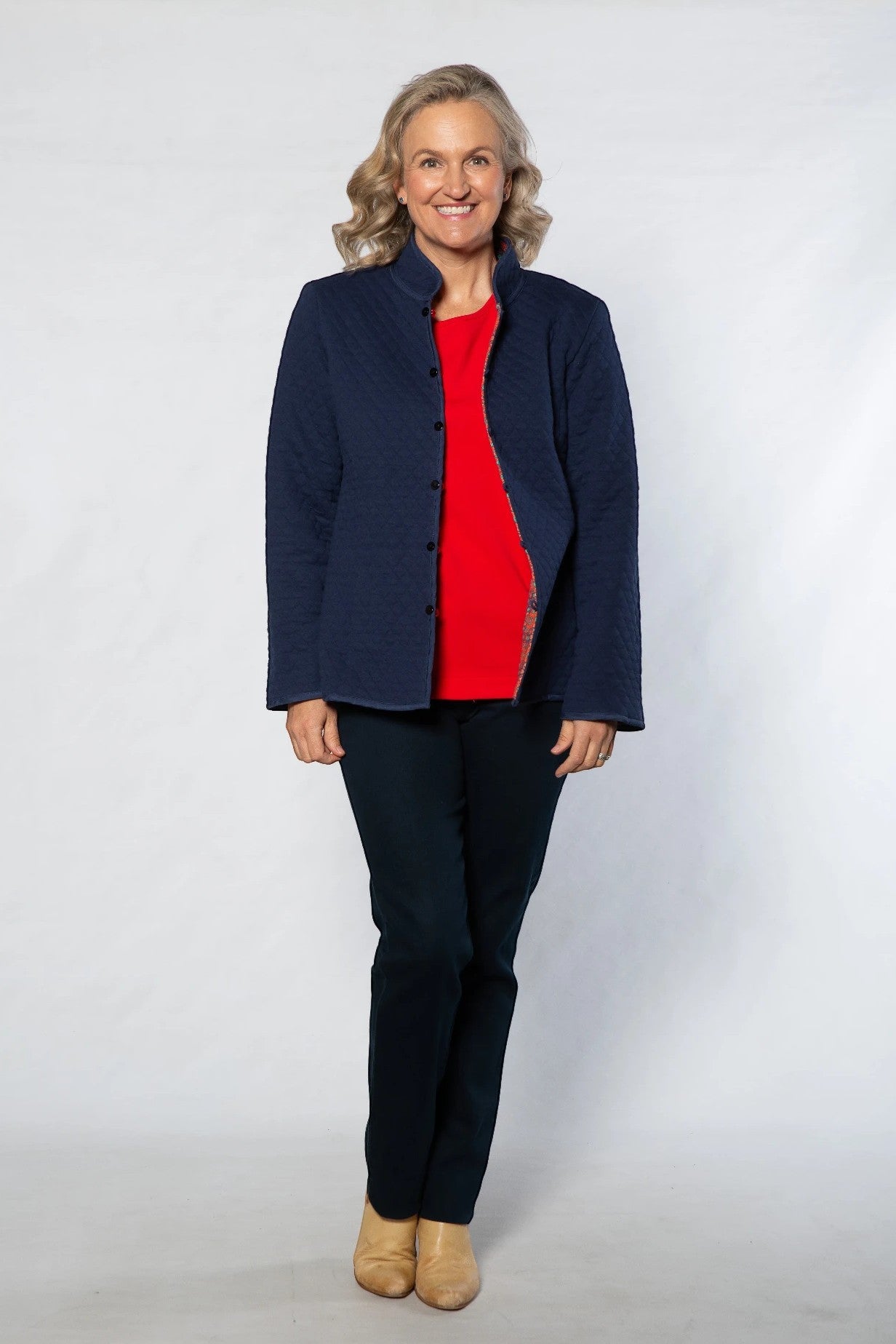 Equinox Clothing reversible oriental jacket in navy quilted cotton blend worn by a woman with a red top