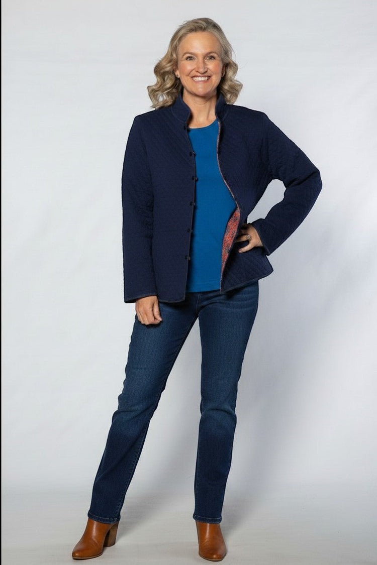 Equinox Clothing reversible oriental quilted jacket in navy blue worn by a woman with a blue top and jeans