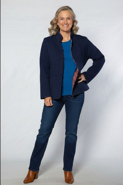 Equinox Clothing reversible oriental quilted jacket in navy blue worn by a woman with a blue top and jeans