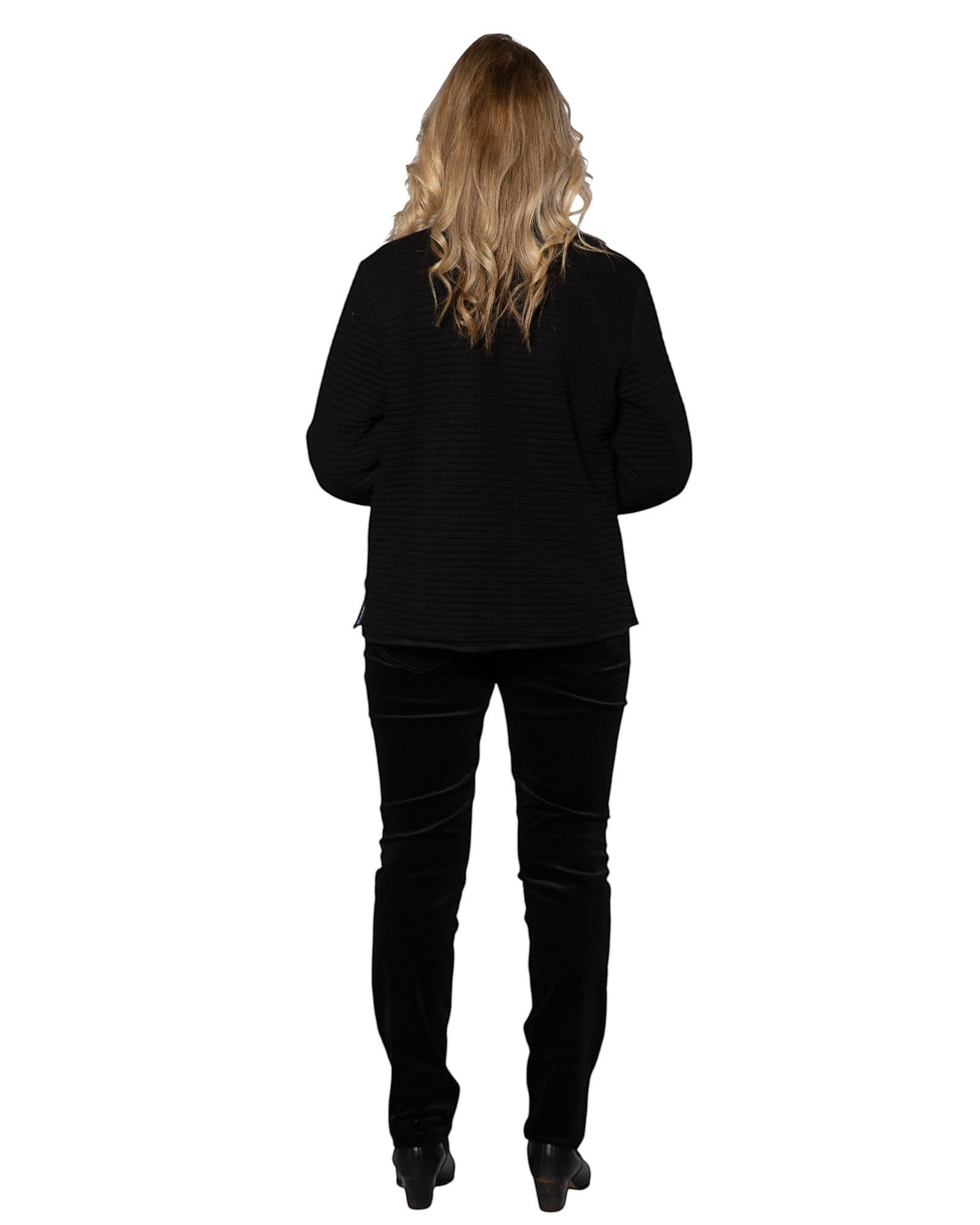 Model wearing Equinox Clothing reversible oriental jacket in black with textured fabric, paired with black trousers.