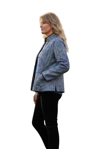 Equinox Clothing reversible oriental jacket in blue and black with patch pockets, worn by a model in a garden.