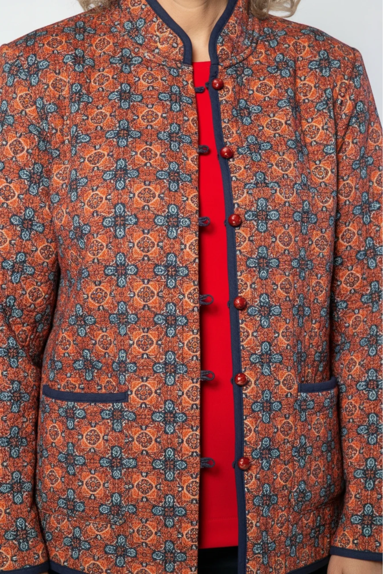 Equinox Clothing reversible oriental jacket in red and navy with quilted cotton-polyester fabric and button loops.