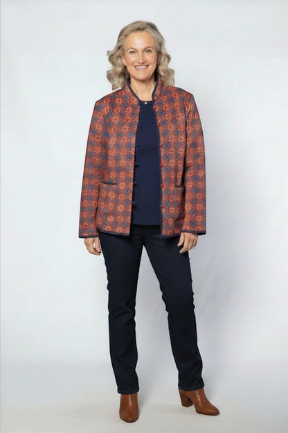 Equinox Clothing reversible oriental jacket in red and navy with quilted pattern, button closure, and patch pockets.