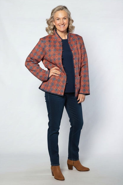 Equinox Clothing reversible oriental jacket in red and navy with quilted fabric and button loops worn by a model